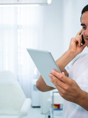 doctor-holding-digital-tablet-while-talking-mobile-phone.jpg